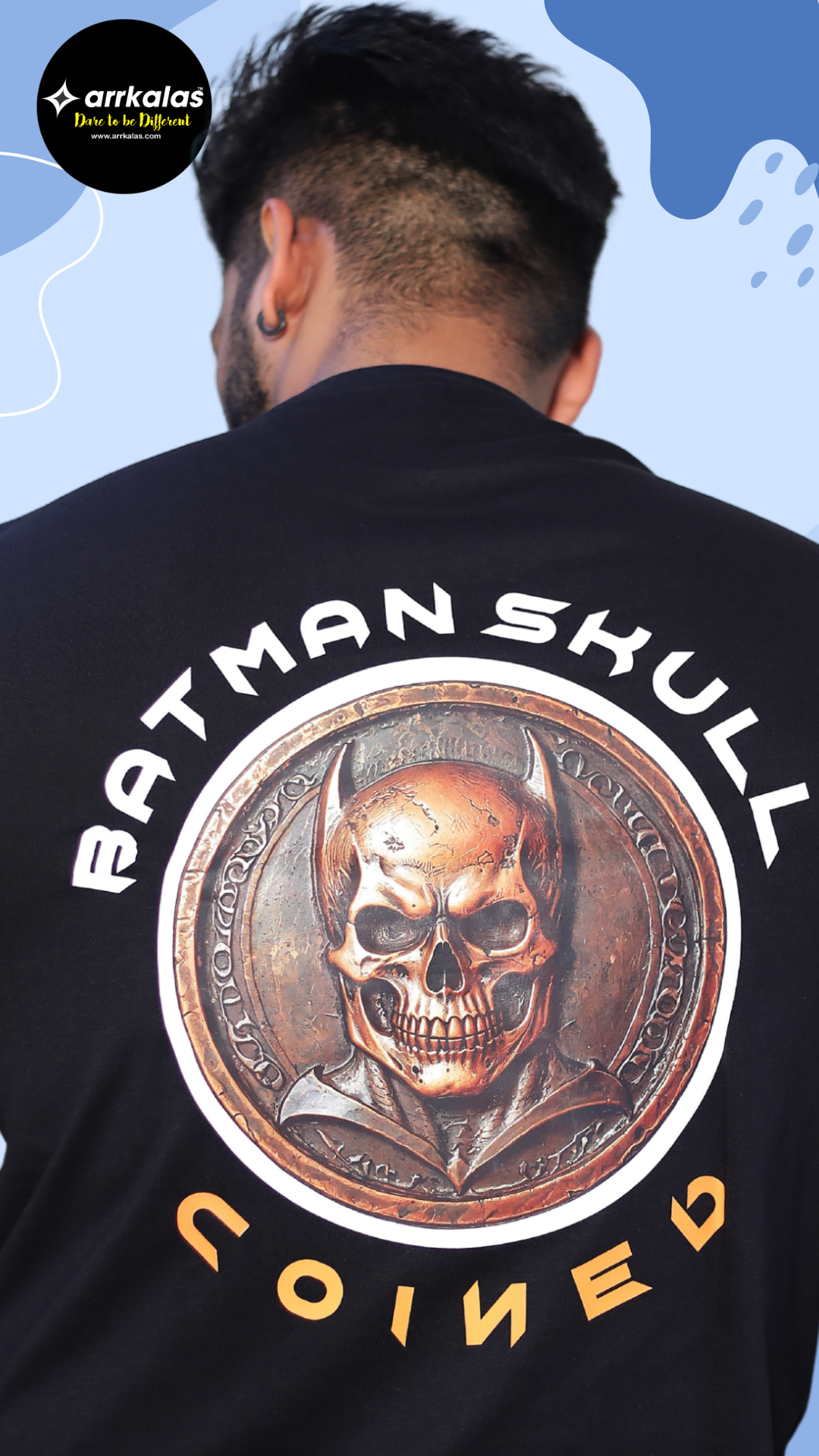 A dark, vintage-style coin featuring a skull with bat-like ears resembling a Batman skull. The bronze medallion has ancient runes etched around the edges, giving it a gothic and mysterious appearance
