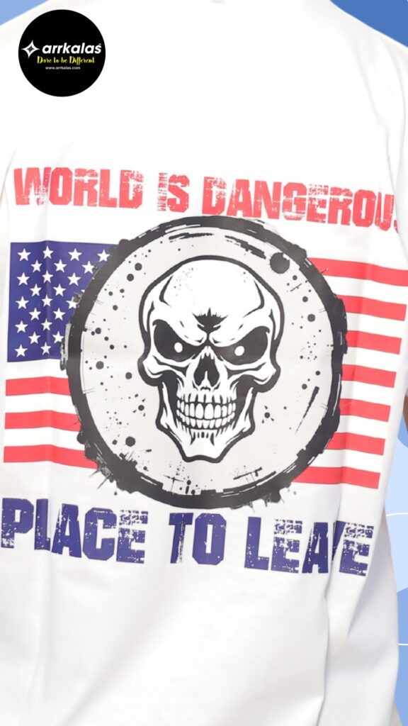 Deadly skull design layered over the American flag with bold text: “World is Dangerous, Place to Leave.” A rebellious, dark message warning of chaos with intense, gritty energy