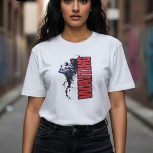 A confident woman stands on an urban street, wearing a white T-shirt with a striking graphic design. The shirt features a bold, artistic profile of a woman rendered in a monochrome, ink-splattered style, paired with the word “WAITING” in large, red vertical lettering. She pairs it effortlessly with black jeans, creating a modern, expressive look that radiates both style and attitude